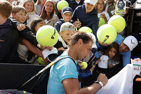 Rafael Nadal sign autographs